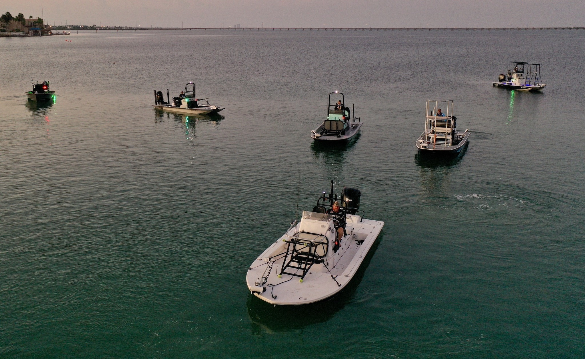 Boaters and docked vessels at Jim's Pier during a calm day