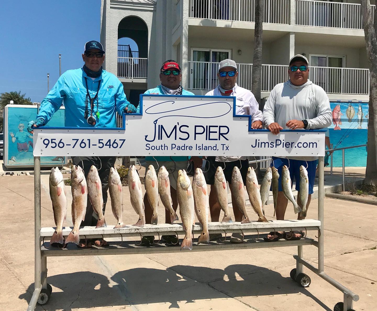 Family fishing photo with a freshly caught fish at the marina